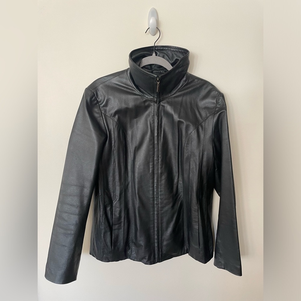 Gently used black leather jacket. Zipper closure.